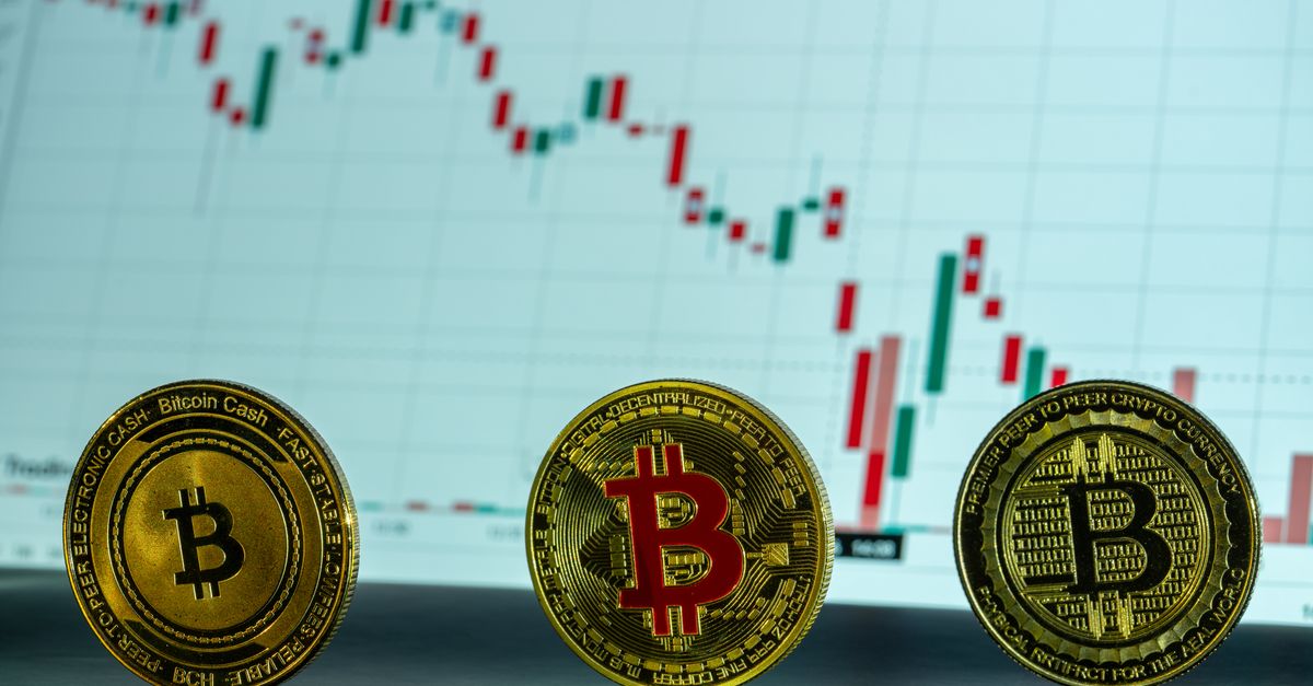 Bitcoin coins displayed in front of a financial market graph, illustrating cryptocurrency trends.